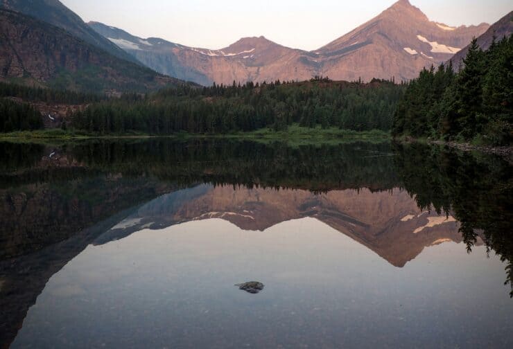 Mountains in the shadow of a lake; cover image on blog comparing the MBTI and SIGMA Personality